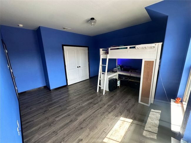 Upstairs bedroom with blue walls, wood finished floors | Image 22