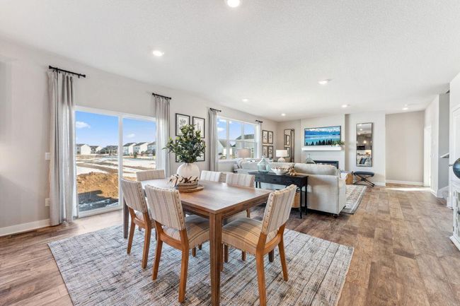 A spacious informal dining area joins the kitchen and living room. Photo of model home, colors and finishes will vary. | Image 12
