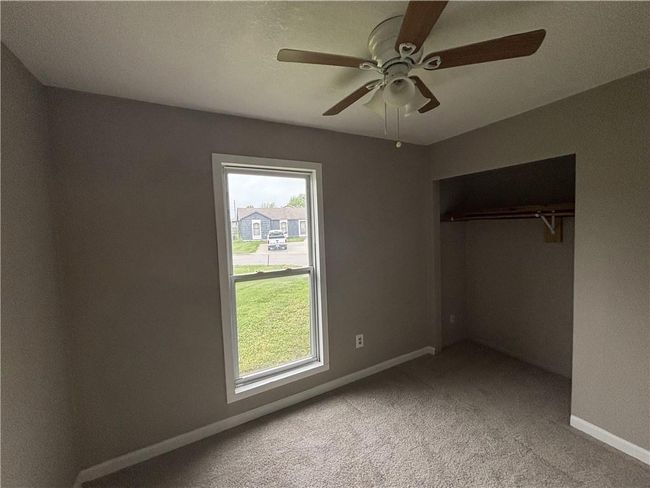 Unfurnished bedroom featuring multiple windows, carpet, and baseboards | Image 19