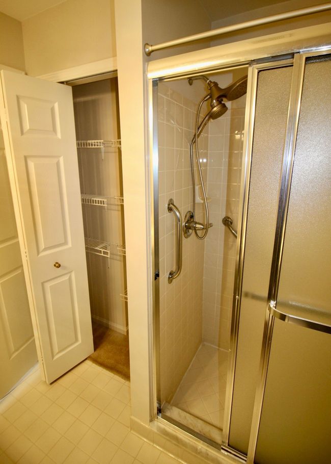 Standing shower and linen closet in primary bath. | Image 13