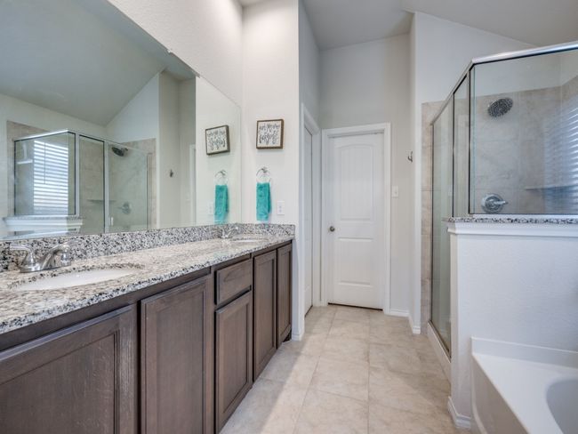 Bathroom featuring a shower stall, double vanity, a garden tub, and tile patterned floors | Image 18