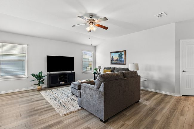 Living area featuring wood finished floors and a ceiling fan | Image 14
