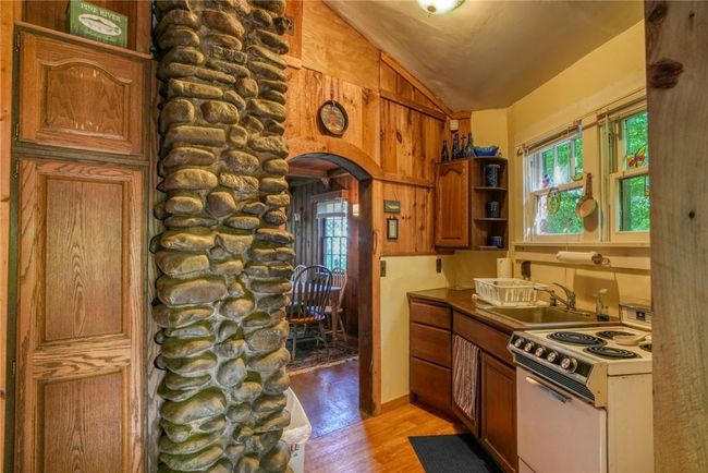 Kitchen featuring sink, lofted ceiling, light hardwood / wood-style floors, and white electric range oven | Image 12