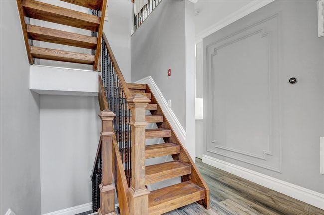 Stairway with wood finished floors and baseboards | Image 13