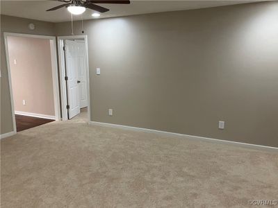 Living room with ceiling fan and carpet | Image 3