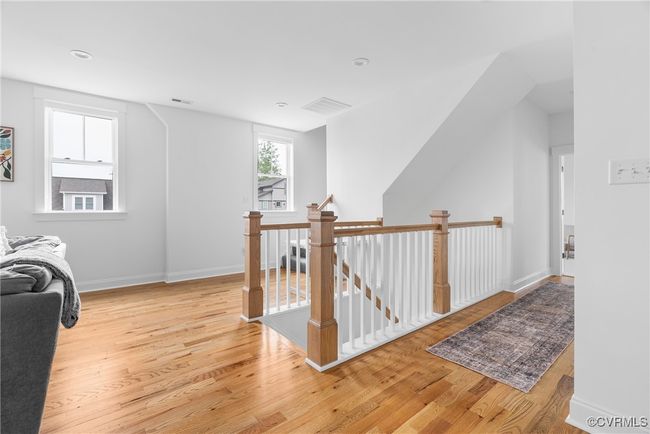 Corridor with an upstairs landing, light wood-style floors, and baseboards | Image 32