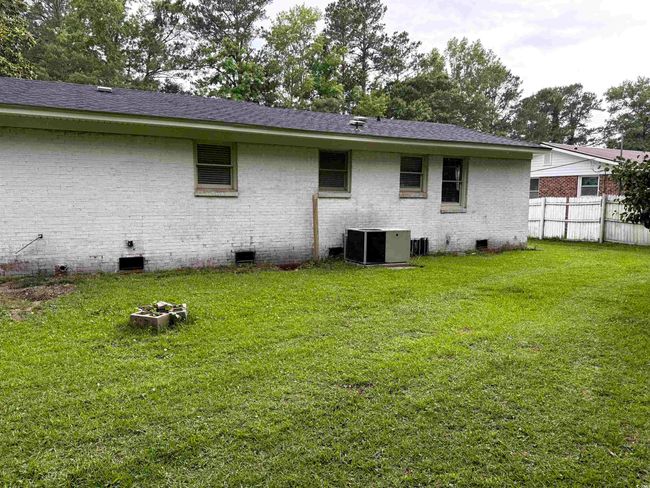 Rear view of property with crawl space, brick siding, a shingled roof, and central air condition unit | Image 19