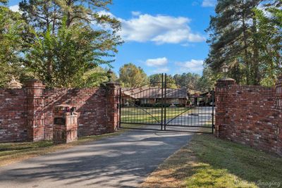 Electric wrought iron gate and brick fence offers privacy and security. | Image 2