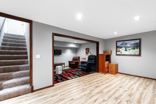 Living area featuring wood finished floors, stairway, and recessed lighting | Image 24