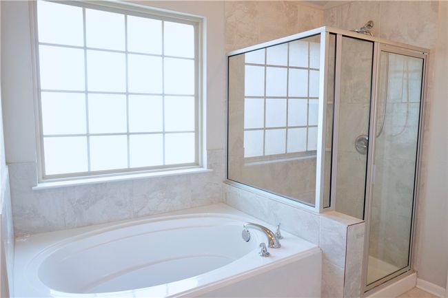 Full bath featuring a garden tub, a stall shower, and healthy amount of natural light | Image 12