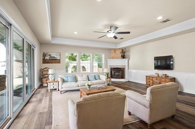 The large gameroom has a pellet stove, two walls of windows, and access to the patio. It is large enough for a gaming area and a pool table. (This photo has been virtually staged to show it's potential.) | Image 29