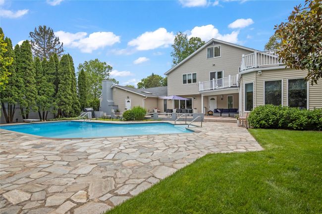 Swimming pool with an outdoor living space, a patio area, and a yard | Image 30