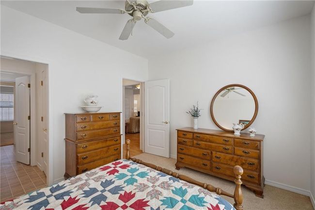 Bedroom with carpet flooring, baseboards, and ceiling fan | Image 37