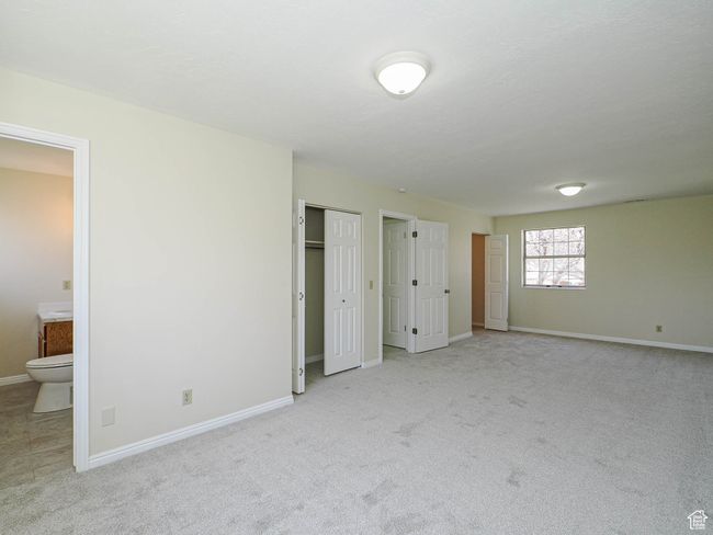 Unfurnished bedroom featuring carpet floors and ensuite bath | Image 38