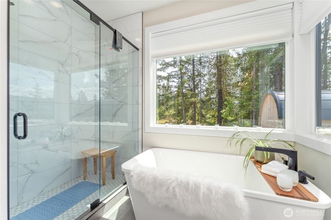 Soak in the freestanding tub surrounded by windows that frame the natural beauty and sweeping mountain views—offering the perfect place to relax and unwind in complete serenity | Image 21