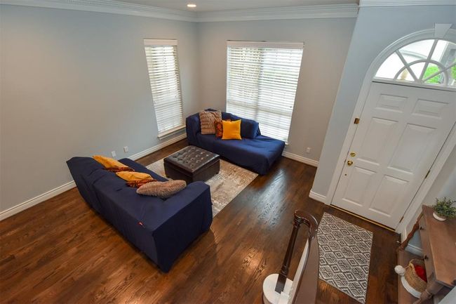 The entryway features a white door with an arched window, adding character to the space. | Image 8