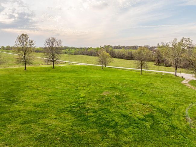 View of property's community with a rural view and a yard | Image 54