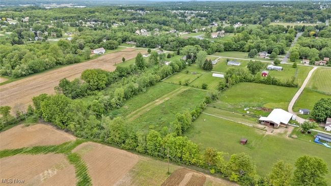 Aerial view of sparsely populated area with a tree filled landscape | Image 35