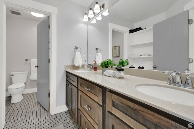 Bathroom featuring double vanity and toilet | Image 38