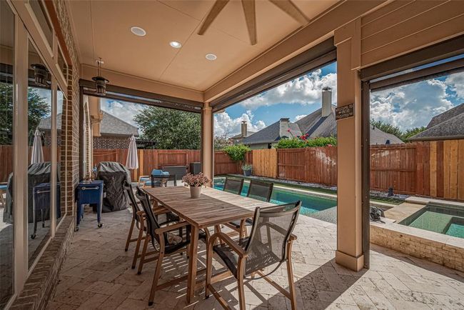 The extended covered patio is the perfect spot to dine al fresco, with ceiling fans keeping the space cool and the breeze flowing. An exterior gas stub is already in place, making it easy to add an outdoor kitchen whenever you're ready. | Image 29