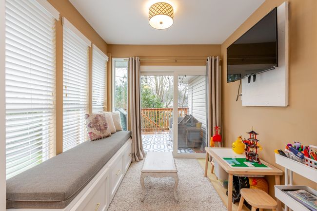 Eating area with brand new built-in bench and new glass patio sliders is currently being used as a kids play area | Image 16