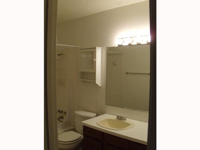 Bathroom featuring toilet, vanity, and shower / bathing tub combination | Image 7