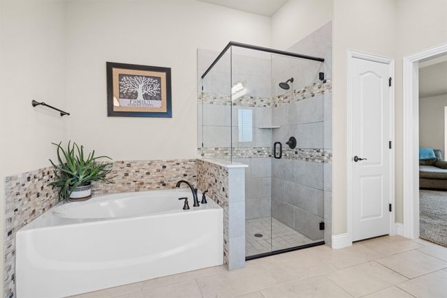 Bathroom with a garden tub, a shower stall, tile patterned floors, and ensuite bathroom | Image 24