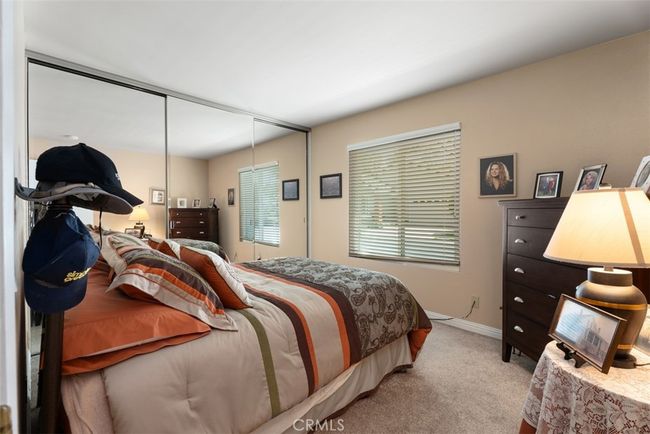 This is a view of the front secondary bedroom complete with mirrored wardrobe doors | Image 8