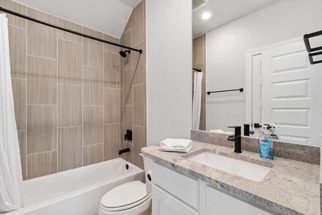 Full bathroom featuring shower / bath combo, vanity, and toilet | Image 20