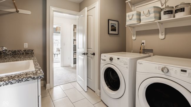 Upstairs laundry room with connection to primary bedroom closet | Image 50