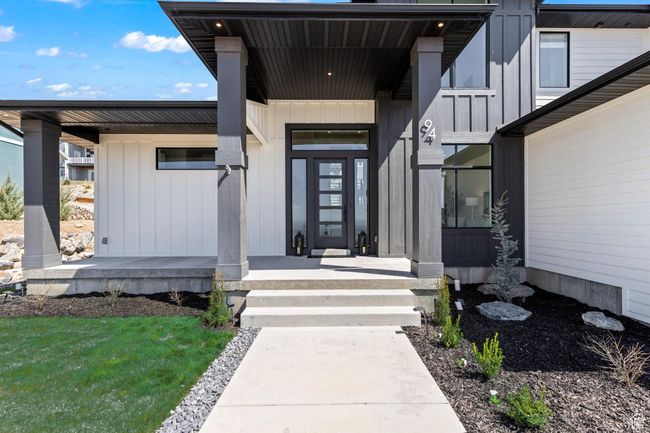 Entrance to property featuring board and batten siding and covered porch | Image 4