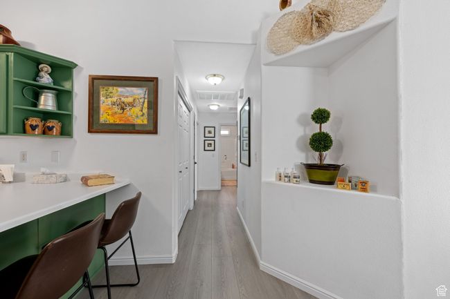 Hall featuring visible vents, baseboards, and light wood-type flooring | Image 11