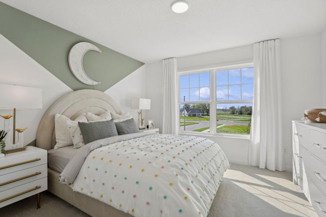 (Photo of a decorated model, actual homes finishes will vary) One of the three spacious secondary bedrooms on the upper level. | Image 17