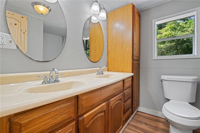 Bathroom featuring double vanity and wood finished floors | Image 11