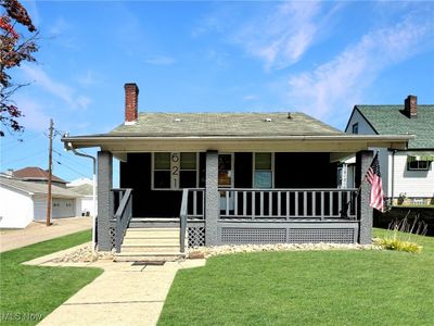 Bungalow with a front yard and covered porch | Image 1