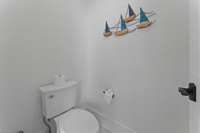 Bathroom featuring toilet and baseboards | Image 26