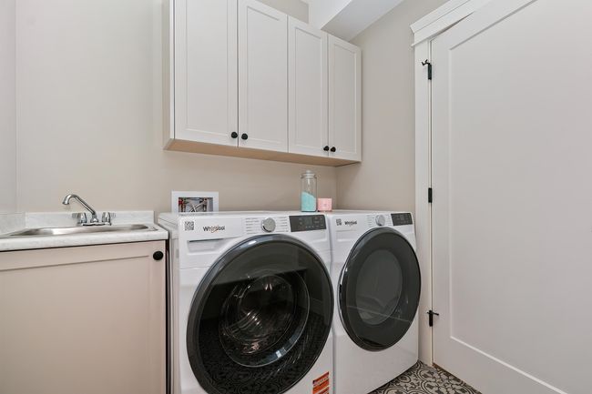 Laundry room featuring cabinet space and independent washer and dryer | Image 17