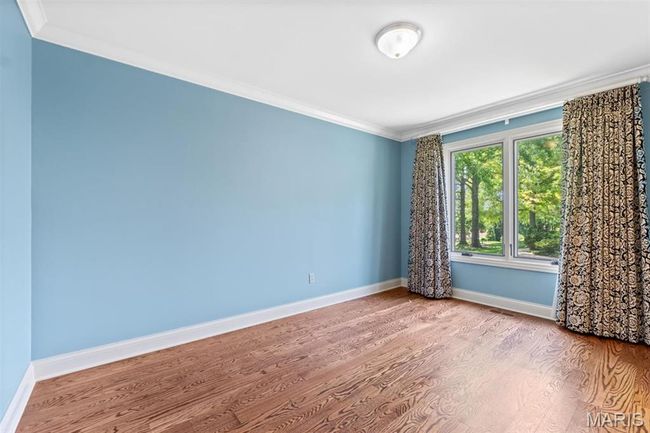 Empty room with crown molding and wood finished floors | Image 26