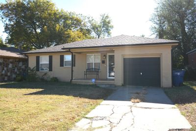 Ranch-style home with a front lawn and a garage | Image 1