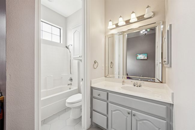 Bathroom featuring vanity, tile patterned floors, and shower / tub combination | Image 17