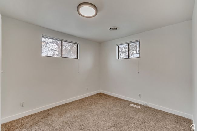 Spare room with visible vents, carpet flooring, and baseboards | Image 22