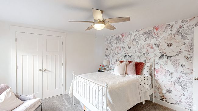 Carpeted bedroom with baseboards, wallpapered walls, a closet, and ceiling fan | Image 36