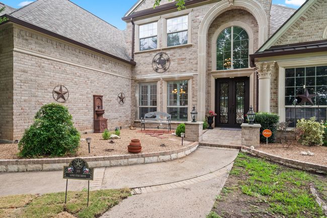 Entrance to property featuring french doors, brick siding, and roof with shingles | Image 40