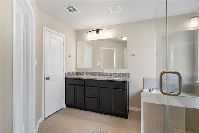 Bathroom with double vanity, tile patterned floors, a shower stall, and a bath | Image 15