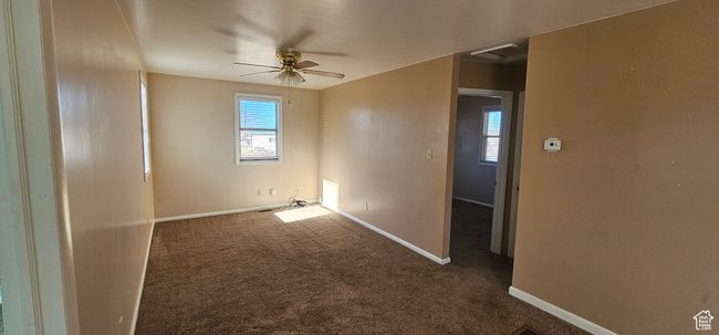 Carpeted empty room featuring ceiling fan | Image 13