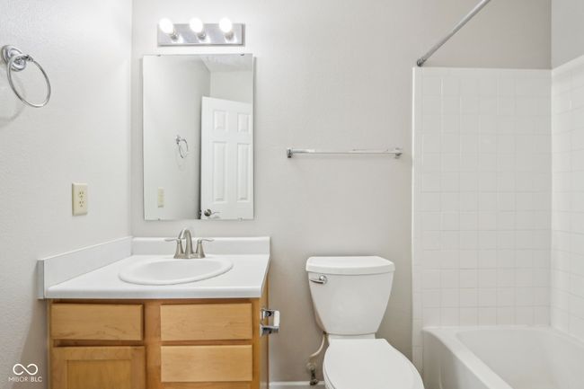 bathroom featuring vanity, toilet, and bathing tub / shower combination | Image 31