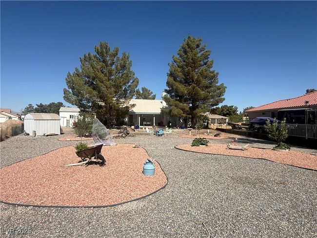 View of front of home with a storage shed and a patio | Image 61