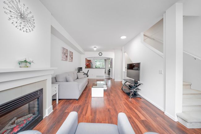 Living area with recessed lighting, a tiled fireplace, baseboards, and wood finished floors | Image 19
