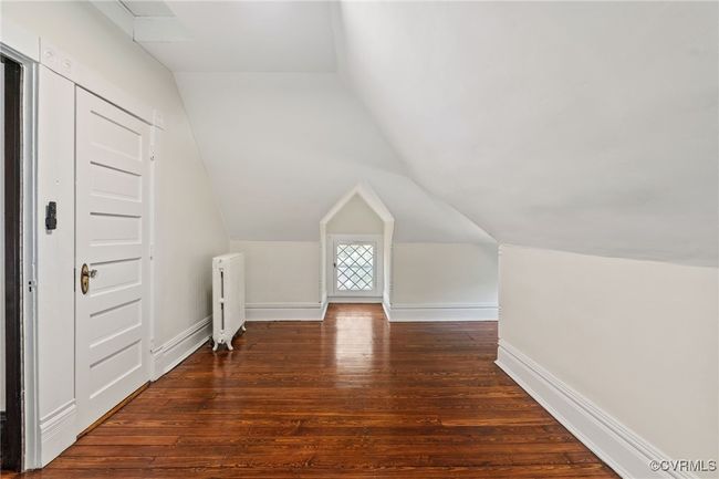Bedroom with hardwood floors, vaulted ceiling, and baseboards | Image 43