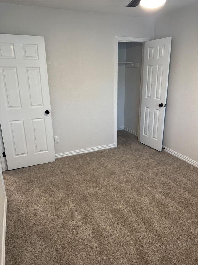 Unfurnished bedroom featuring carpet flooring, baseboards, and a closet | Image 11